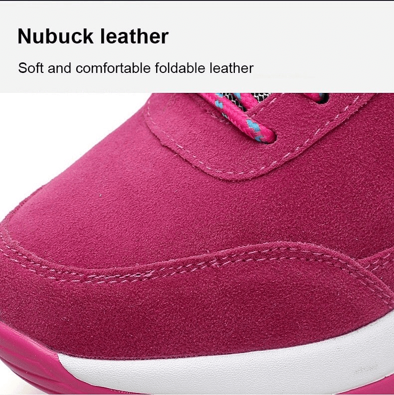 Close-up of pink suede women's sneaker with soft nubuck leather, showcasing stitching and lace-up detail.